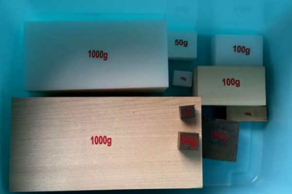 A set of square products made of various materials (wood, metal, plastic)